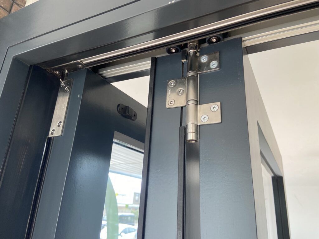 aluminium bi fold doors with heavy duty hinge and top track detail finished in anthracite grey bifold doors trinity windows jersey 2500