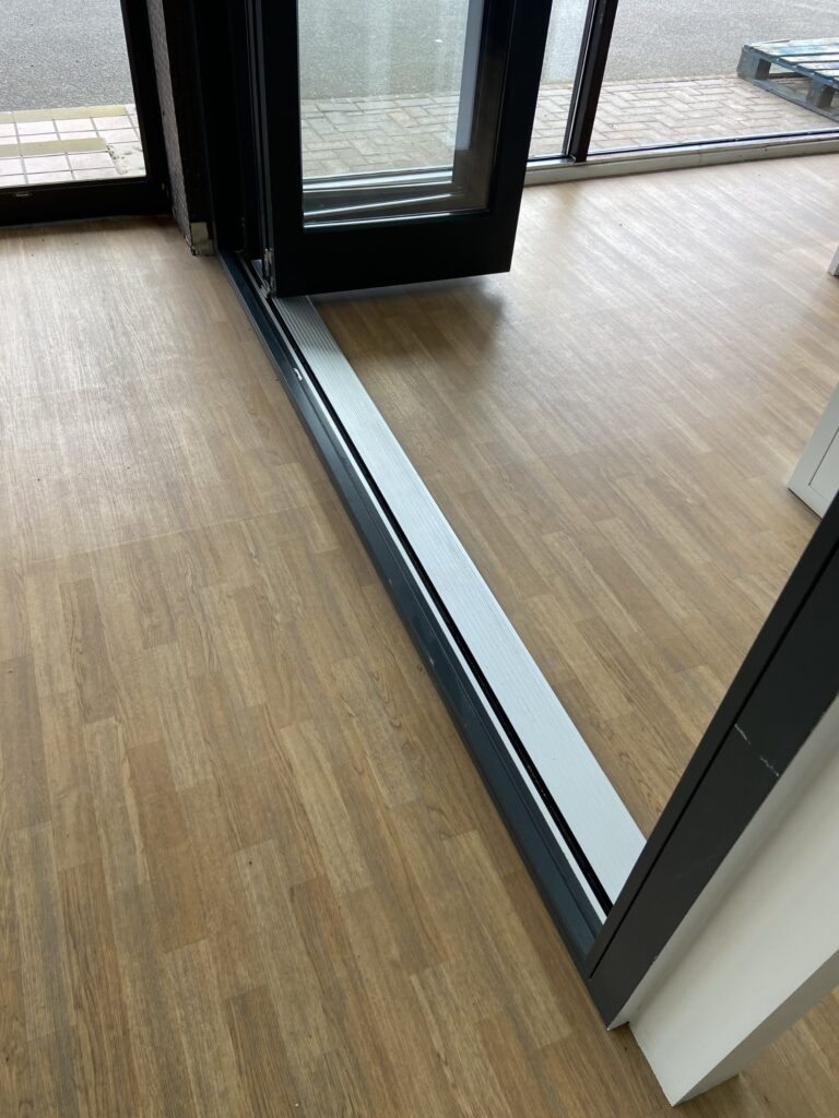 aluminium bi fold doors with low threshold track detail finished in anthracite grey bifold doors trinity windows jersey 2500