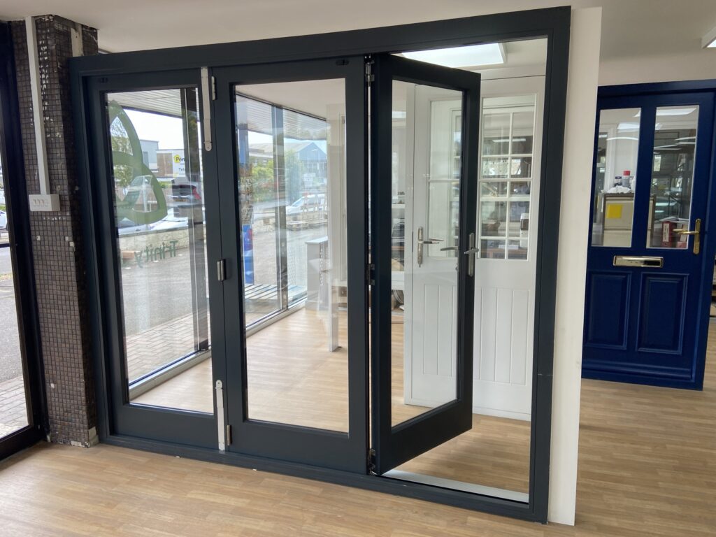 aluminium bi fold doors with slimline frames finished in anthracite grey bifold doors trinity windows jersey 2500