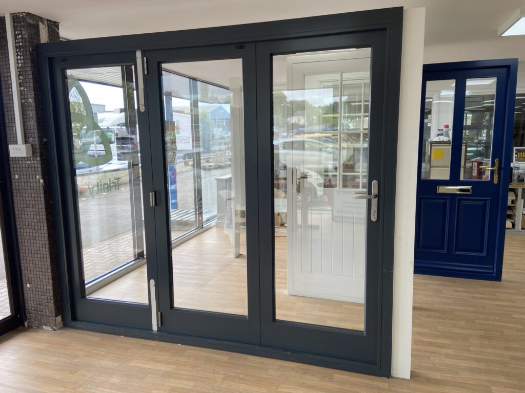 aluminium bi fold doors with slimline frames finished in anthracite grey closed view bifold doors trinity windows jersey 2500