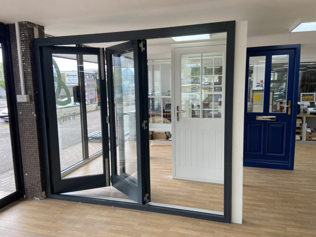 aluminium bi fold doors with slimline frames finished in anthracite grey open view bifold doors trinity windows jersey 2500