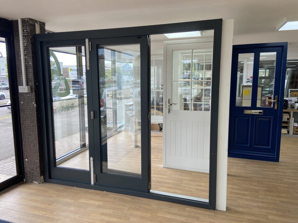 aluminium bi fold doors with slimline frames finished in anthracite grey part open view bifold doors trinity windows jersey 2500