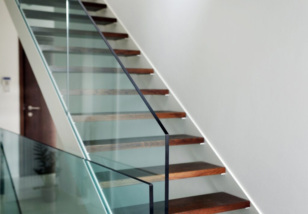glass-balustrade-with-dark-wood-floating-stairs-glass-balustrades-trinity-windows-jersey