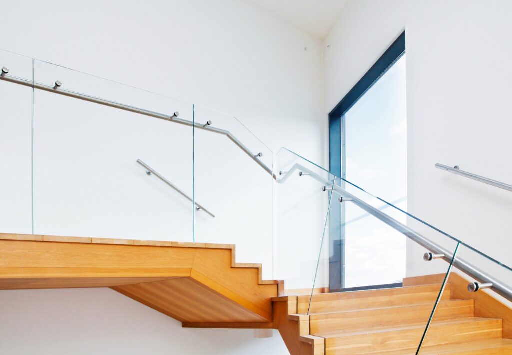 glass balustrade with stainless steel handrails on floating wooden staircase glass balustrades trinity windows jersey 2500